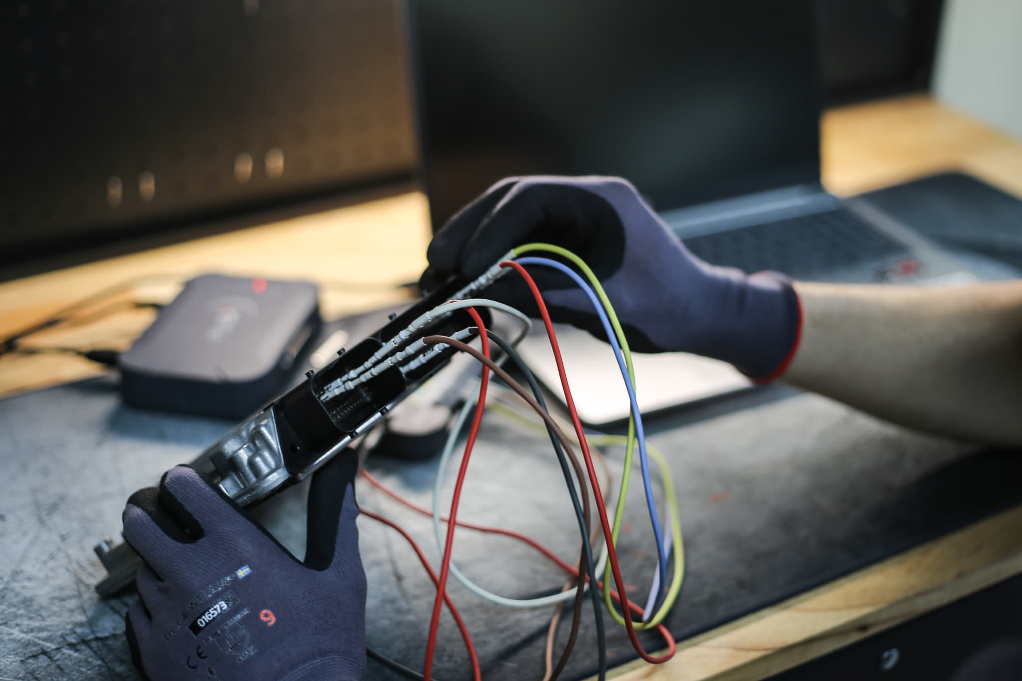 Workshop technician performing ECU tuning on a vehicle